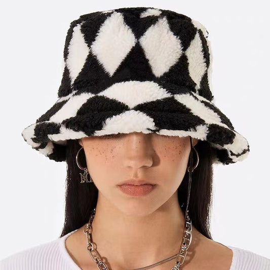Black and white sherpa diamond check bucket hat, crafted from soft polyester in a sophisticated cozy style.