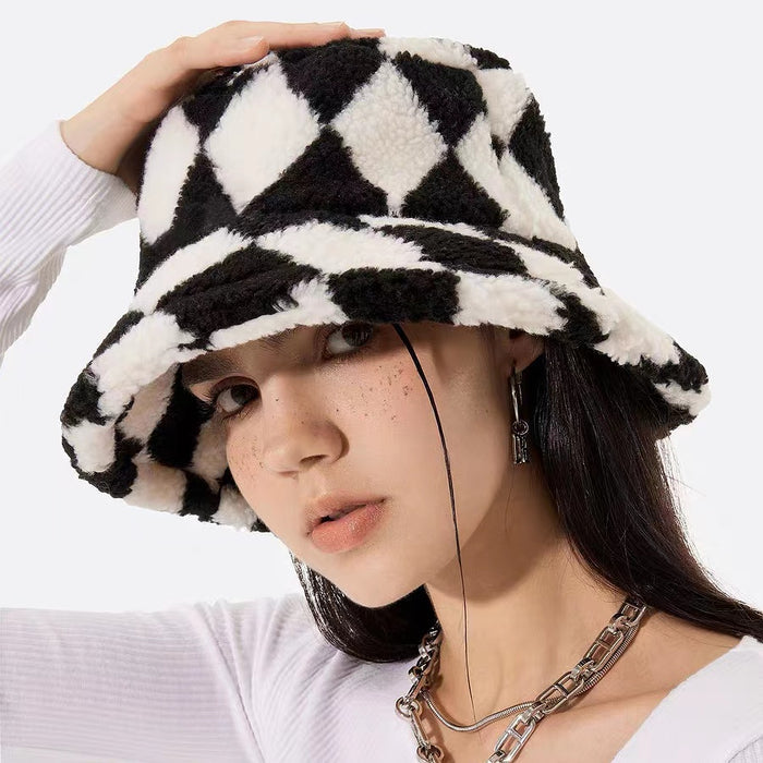Black and white sherpa diamond check bucket hat on a model, highlighting a trendy geometric winter aesthetic.