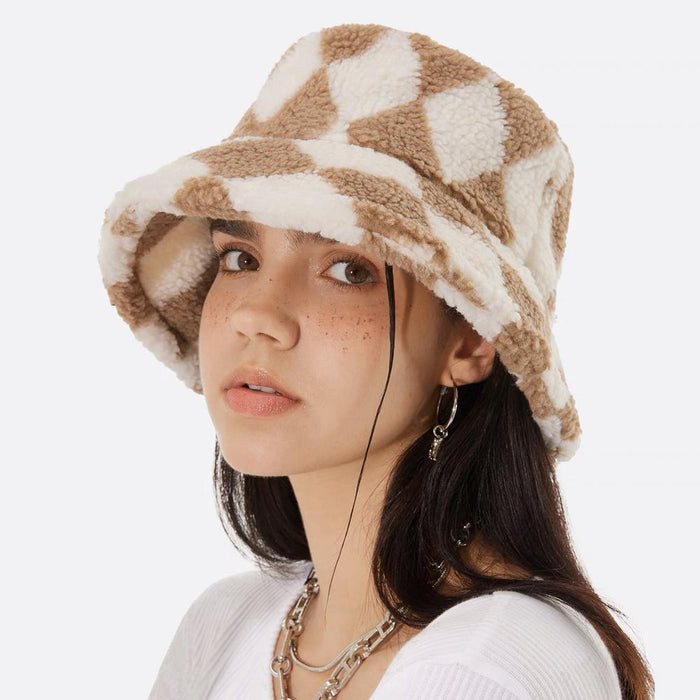 Model wearing Sherpa Diamond Check Bucket Hat in khaki, featuring sophisticated geometric patterns for winter.