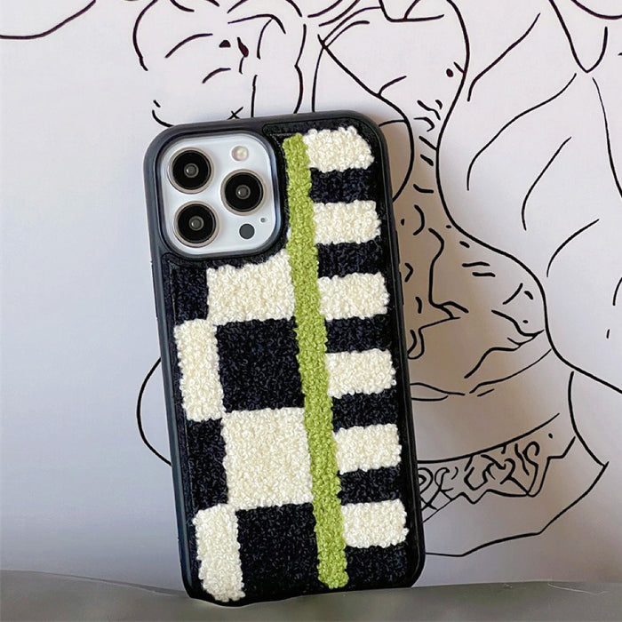 Sherpa green stripe case featuring a black and cream plaid texture and prominent green stripe.