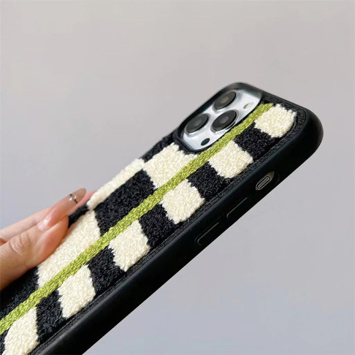 Side view showing the thickness and fuzzy edges of the Sherpa Green Stripe case.