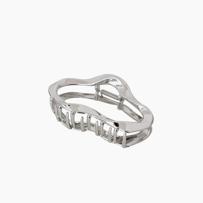 Front view of Silver metal hair claw with a wavy, cloud-like design.