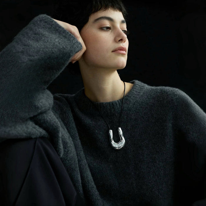 Model wearing a silver Crescent Pendant Necklace, great for parties, weddings, and dates.