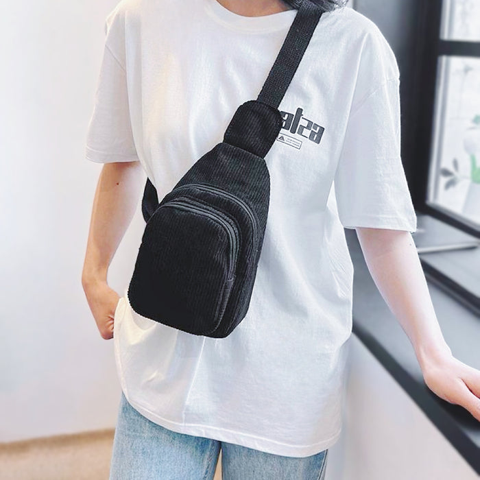Model carrying a black sling bag as crossbody , easy for commuting and weekends.