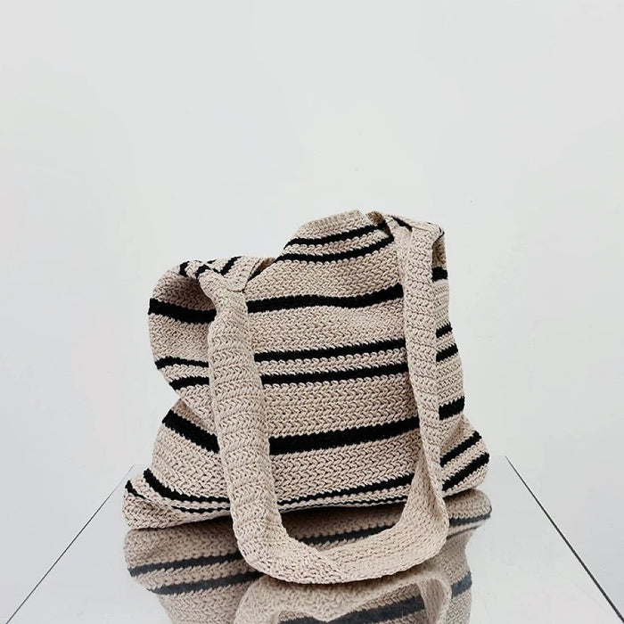 Folded view of oat and black Simple Striped Knitted Bag, easy for commuting and weekends.