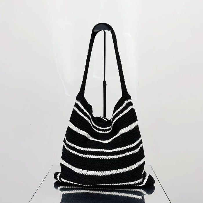Angled view of Simple Striped Knitted Bag in black and white, great for everyday carry and travel.