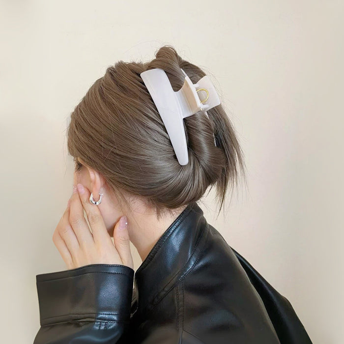 Model wearing a Sleek Curved Hair Clawp in white, ideal for quick updos and ponytails.