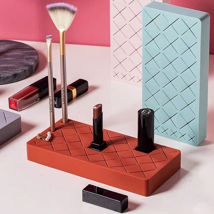 Front view of  silicone makeup holder with slots, holding brushes, lipsticks, and jewelry.