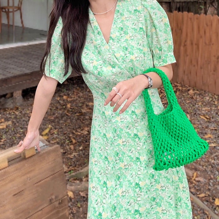 Model carrying a green Crochet  handbag handheld, ideal for city walks and gifting.