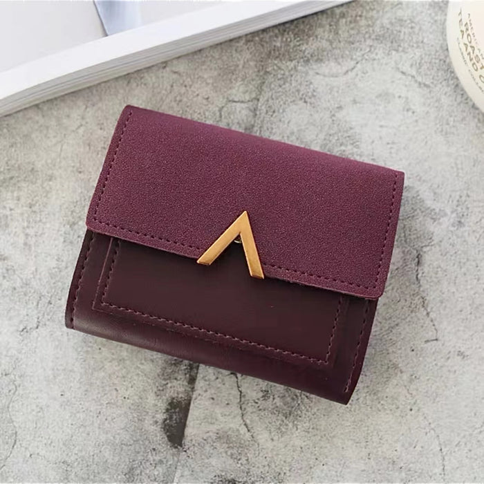 Flat lay of Small Wallet With Nubuck Leather Flap in burgundy, great for everyday carry and travel.