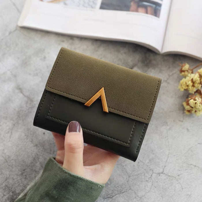 Model holding Small Wallet With Nubuck Leather Flap in green, ideal for commuting and gifting.