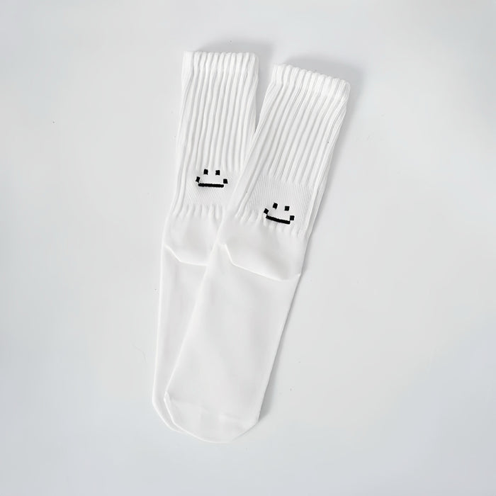 Folded view of Smile Slouch Socks in white, ideal for workouts and commuting.