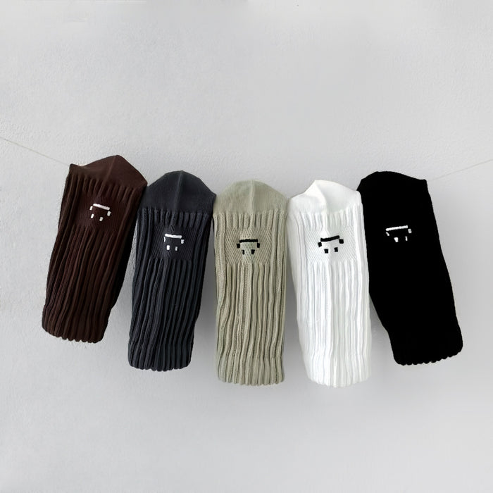 Close-up of 5 pairs of Smile Slouch Socks shown together, ideal for workouts and commuting.