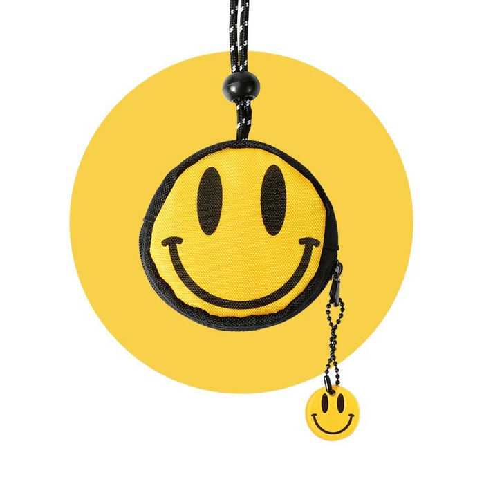 Smiley coin purse with key lanyard: yellow round zip pouch with black trim and mini smile charm for everyday carry.
