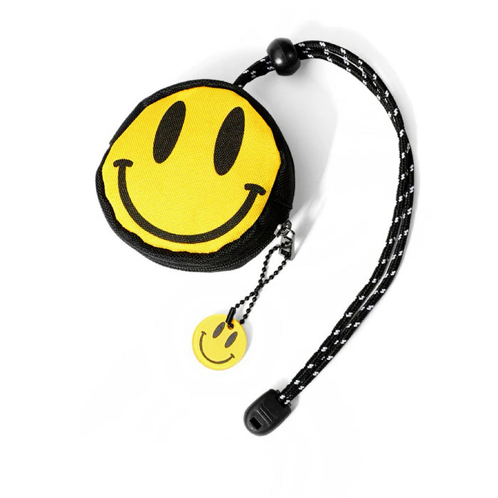 Smiley coin purse with long black cord lanyard; compact round zip pouch for coins and small essentials.