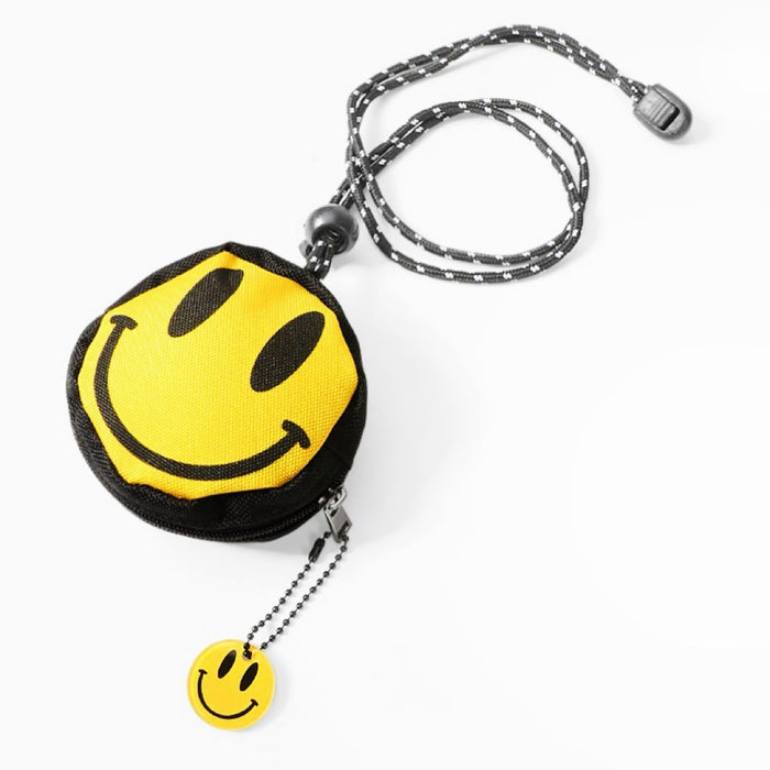 Angled smiley coin purse with charm; round zip pouch and adjustable lanyard for keys or quick errands.