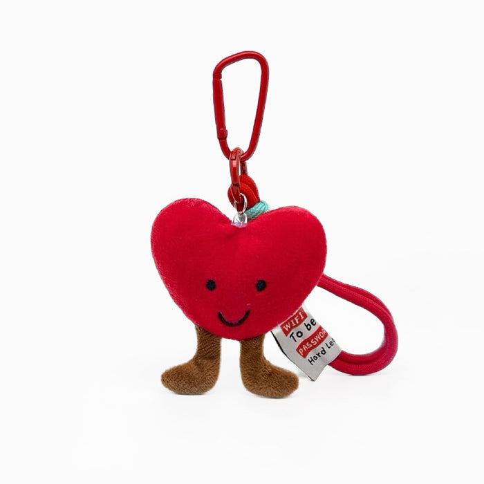Front view of Red plush heart bag charm with smiling face, brown legs, and red carabiner clip.