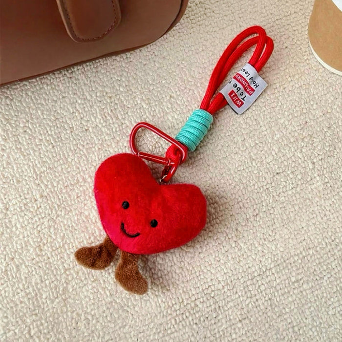 Angled view of Smiling Heart Bag Charm, easy to attach to bags and phones.