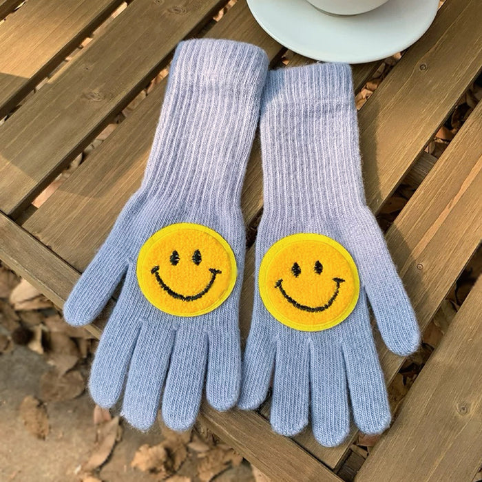 Baby blue smiling round face gloves with soft knit texture; cute cozy gloves for winter outings.