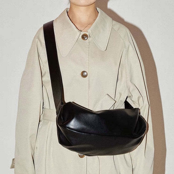 Model carrying a black baguette bag as crossbody, great for daily carry and travel.