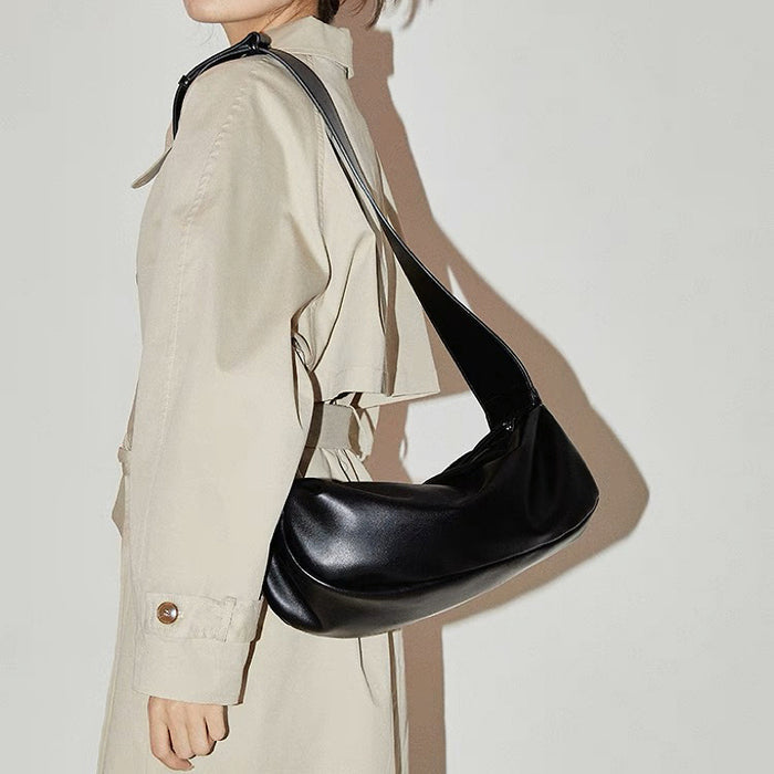 Model carrying a black Soft Leather Baguette Bag on shoulder, easy for commuting and weekends.