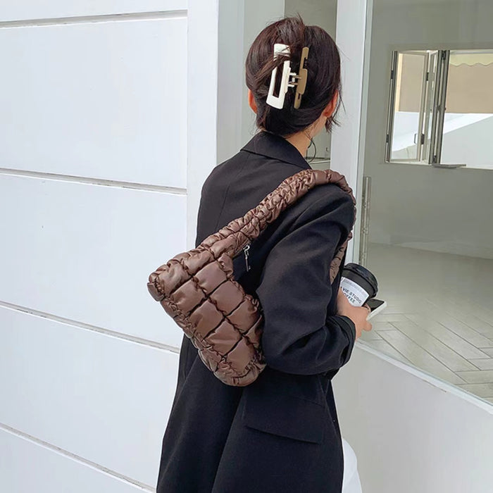 Model wearing a brown PU leather soft puffer shoulder bag with quilted design, easy for commuting and weekends.