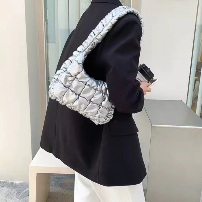 Model carrying a silver Soft Leather Puffer Bag on shoulder, great for daily carry and travel.