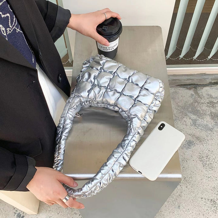 Angled view of  Soft Leather Puffer Shoulder Bag in silver, easy for commuting and weekends.