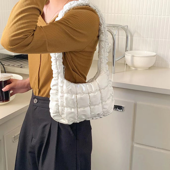 Model carrying a white Soft Leather Puffer Shoulder Bag, easy for commuting and weekends.