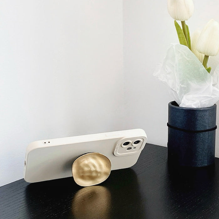 Side view of cream Solid Color Case. Sophisticated matte texture and gold kickstand for hands-free use.