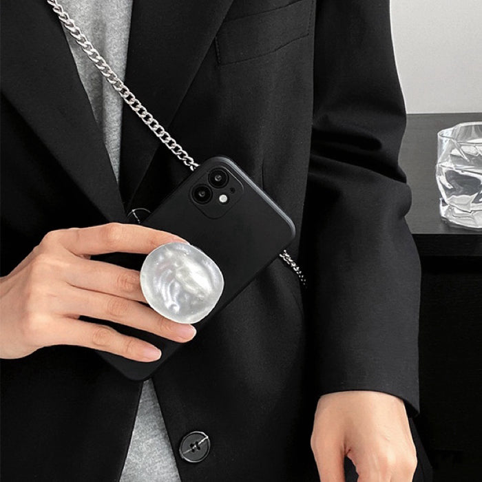 Model holding black Solid Color Case. Sleek professional matte finish with a durable gold stand.