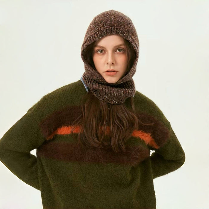 Woman wearing a speckled brown balaclava with a matching olive green sweater for a cozy winter set.