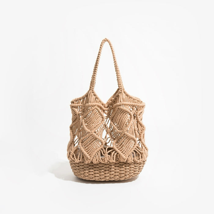 Front view of spiral pattern hollow crochet bag with woven base and braided handle in camel.