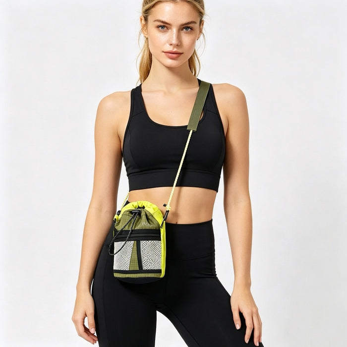 Woman in black activewear with a sporty mini bucket crossbody bag, featuring braided rope strap and mesh