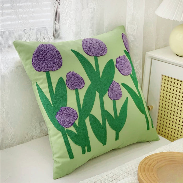 Angled view of Spring Vibe Pillow Cover with embroidered grass and flowers.