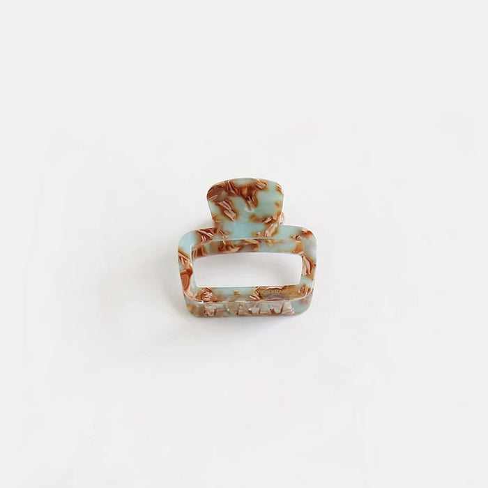 Cyan marbled square hair claw with glossy finish, ideal for refreshing spring hair styling.