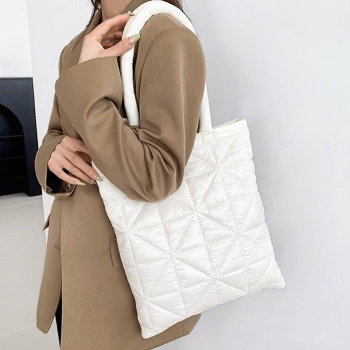 Model carrying a white polyester shoulder bag, great for daily carry and travel.