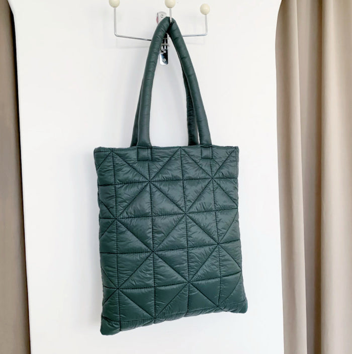 Angled view of Starburst Quilted Shoulder Bag in green, great for everyday carry and travel.