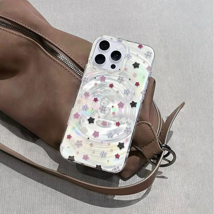 Clear acrylic case with iridescent ripple effect and scattered pink, black, and white stars.