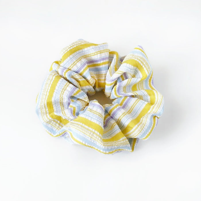 Close-up of Stripe Dream Scrunchie in yellow, easy for workdays and special occasions.
