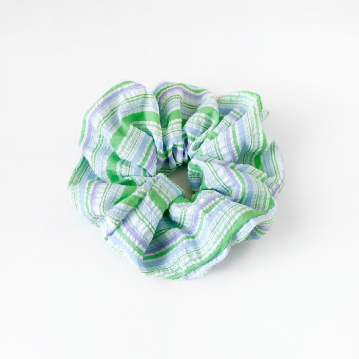 Flat lay of Stripe Dream Scrunchie in green, great for everyday styling and gifting.