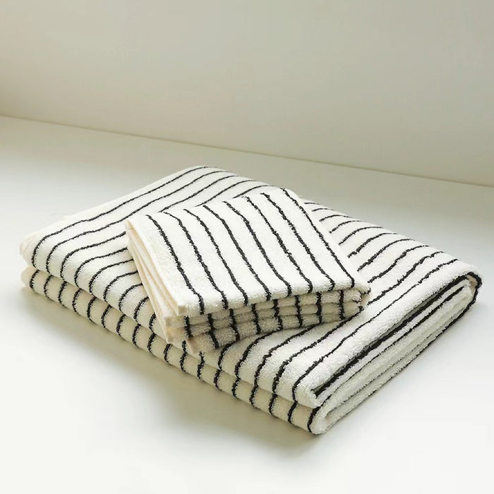 A set of striped face towel and bath towel, stacked together.