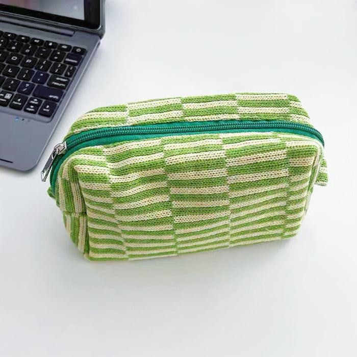 Front view of green striped knitted makeup bag, easy to pack for trips and daily use.