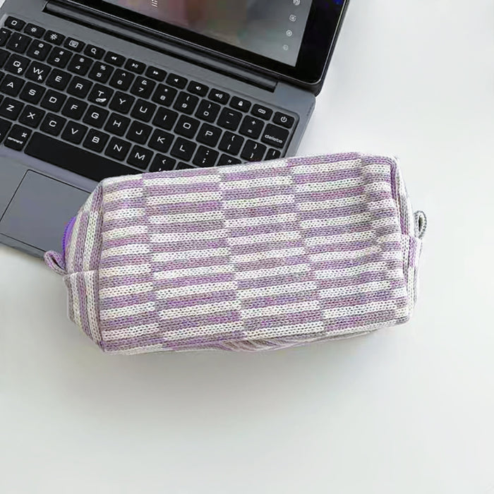 Front view of purple striped knitted makeup bag, ideal for travel makeup and toiletries.