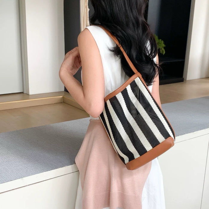 Model carrying a brown striped bag on the shoulder, great for daily carry and travel.