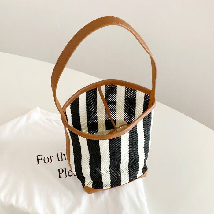 Folded view of Stripe Woven Bucket Bag, easy for commuting and weekends.
