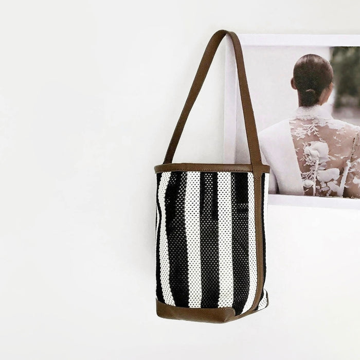 Angled view of Stripe Woven Bucket Bag, great for everyday carry and travel.