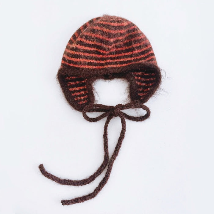 Orange and brown striped earflap hat with a minimalist and cozy knit design.