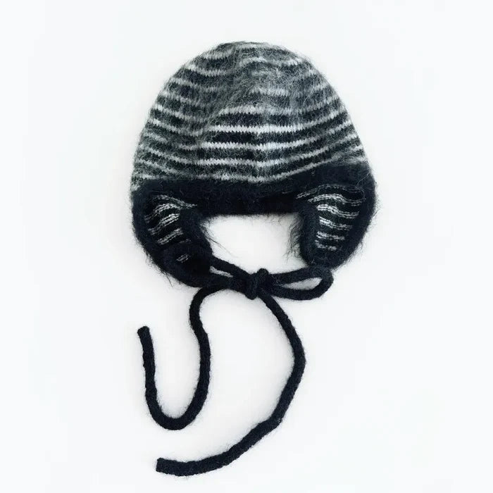 Black and white striped earflap hat with a minimalist knit design.