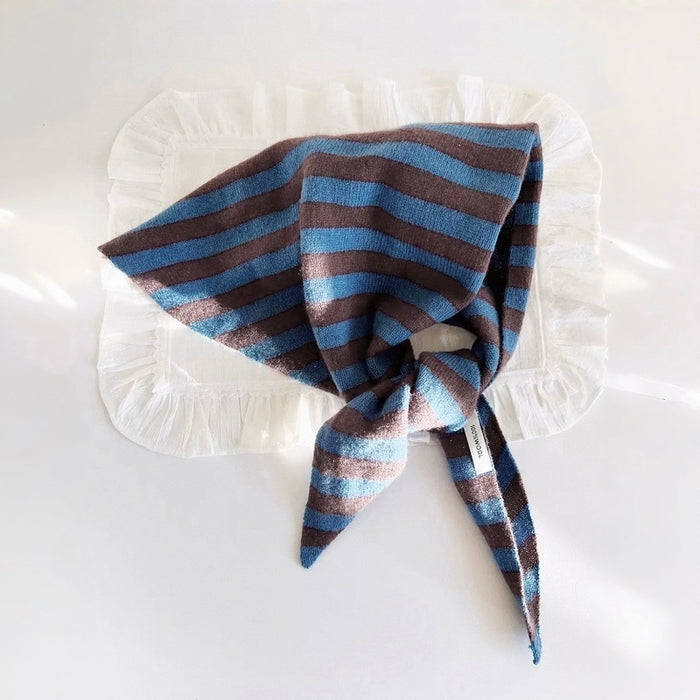 Angled view of the striped wool triangle scarf showing the knit texture in blue, great for office layering.